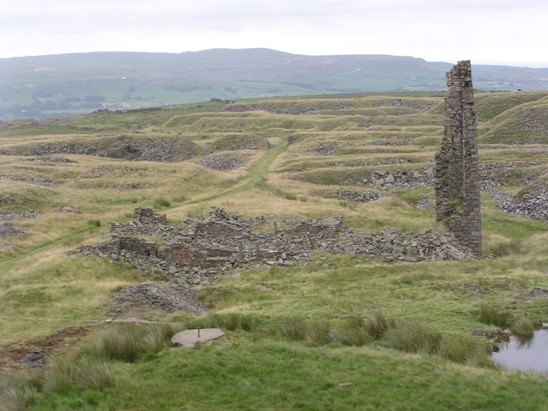 Processing site in 2003 showing damaged chimney and tip patterns in the background