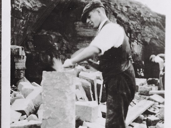 Mason shaping a kerb stone